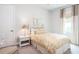 Comfortable bedroom with a woven side table, white bedding, and a window with elegant curtains at 2242 Soaring Eagle Pl, Lake Mary, FL 32746