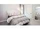 Comfortable bedroom featuring neutral tones, a decorative mirror and a window with natural light at 2242 Soaring Eagle Pl, Lake Mary, FL 32746