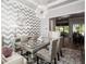 Elegant dining room featuring a glass table, patterned chairs, and a striking chandelier at 2242 Soaring Eagle Pl, Lake Mary, FL 32746