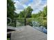 Scenic view from a wooden dock on a tranquil lake, dotted with lily pads and surrounded by lush trees at 2242 Soaring Eagle Pl, Lake Mary, FL 32746