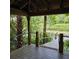 Scenic view from a covered wooden dock overlooking a tranquil lake with lily pads and lush forest surroundings at 2242 Soaring Eagle Pl, Lake Mary, FL 32746