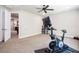 Spacious exercise room with stationary bike, neutral colors, and access to other rooms at 2242 Soaring Eagle Pl, Lake Mary, FL 32746