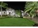 Beautiful home exterior at night, featuring manicured landscaping and a paver driveway at 2242 Soaring Eagle Pl, Lake Mary, FL 32746