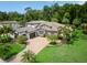 An attractive house featuring a three-car garage, paver driveway, verdant lawn, and mature landscaping at 2242 Soaring Eagle Pl, Lake Mary, FL 32746