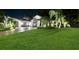 Elegant home exterior with a spacious lawn, manicured landscaping and a well lit driveway at 2242 Soaring Eagle Pl, Lake Mary, FL 32746