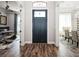 Inviting foyer showcasing hardwood floors, a stylish front door, and views into the adjacent dining and living areas at 2242 Soaring Eagle Pl, Lake Mary, FL 32746