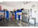 Well-organized garage featuring ample storage cabinets, workspace, stainless refrigerator, and polished concrete flooring at 2242 Soaring Eagle Pl, Lake Mary, FL 32746
