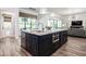 Kitchen featuring dark cabinetry, a large granite island and modern appliances at 2242 Soaring Eagle Pl, Lake Mary, FL 32746