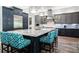 Gourmet kitchen featuring a large granite island and custom blue cabinetry at 2242 Soaring Eagle Pl, Lake Mary, FL 32746