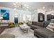 Spacious living room with stylish furnishings, hardwood floors, and an open layout leading to the kitchen and dining areas at 2242 Soaring Eagle Pl, Lake Mary, FL 32746