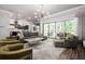 Open-concept living room with contemporary decor, a comfortable sectional sofa, and an inviting view of the outdoor patio at 2242 Soaring Eagle Pl, Lake Mary, FL 32746