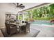 Covered outdoor dining area with ceiling fan and pool view at 2242 Soaring Eagle Pl, Lake Mary, FL 32746