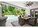 Covered outdoor dining area with ceiling fan, pool view, and exterior landscape at 2242 Soaring Eagle Pl, Lake Mary, FL 32746