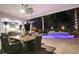 Elegant outdoor dining area with a large table, ceiling fan, and views of the pool at 2242 Soaring Eagle Pl, Lake Mary, FL 32746