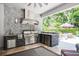Outdoor kitchen with stainless steel grill, hood, sink, and beverage cooler at 2242 Soaring Eagle Pl, Lake Mary, FL 32746