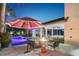 Backyard featuring an outdoor fire pit, covered patio, outdoor bar, and a glimpse of the pool at 2242 Soaring Eagle Pl, Lake Mary, FL 32746