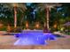 Inviting backyard pool area featuring palm trees, ambient lighting, and lush landscaping at 2242 Soaring Eagle Pl, Lake Mary, FL 32746