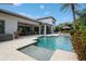 Inviting backyard pool with sundeck, outdoor kitchen, and lounge areas amidst lush landscaping at 2242 Soaring Eagle Pl, Lake Mary, FL 32746