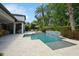 Stunning pool with waterfall feature and well-manicured landscaping creating a private oasis at 2242 Soaring Eagle Pl, Lake Mary, FL 32746