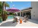 Entertaining backyard with pool, outdoor kitchen, and patio with comfortable seating and a purple umbrella at 2242 Soaring Eagle Pl, Lake Mary, FL 32746