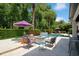 Cozy poolside patio featuring comfortable seating around a fire pit, perfect for relaxing outdoors at 2242 Soaring Eagle Pl, Lake Mary, FL 32746