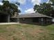 View of the back of the home, featuring a patio and a large backyard at 5190 Starling Dr, Mulberry, FL 33860