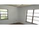 Bedroom featuring two large windows offering ample natural light at 5190 Starling Dr, Mulberry, FL 33860