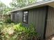 Exterior view of home and landscaping around the side of the property at 5190 Starling Dr, Mulberry, FL 33860