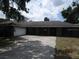Traditional single-story home with an attached two-car garage and large driveway at 5190 Starling Dr, Mulberry, FL 33860