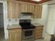 Kitchen features stainless steel stove and wood cabinets at 5190 Starling Dr, Mulberry, FL 33860