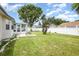Spacious backyard featuring a well-maintained lawn, a white picket fence and a lovely patio area at 216 Kingshill Se Ct, Winter Haven, FL 33884