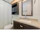 Bathroom with dark wood cabinets, neutral countertop and a shower with curtain at 216 Kingshill Se Ct, Winter Haven, FL 33884