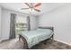Bedroom featuring a bed, window with curtains and blinds and ceiling fan at 216 Kingshill Se Ct, Winter Haven, FL 33884