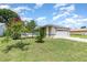 Charming single Gathering home featuring mature trees and a manicured front lawn at 216 Kingshill Se Ct, Winter Haven, FL 33884