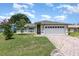 Charming one-story home with a brick driveway, well-maintained lawn, and inviting curb appeal at 216 Kingshill Se Ct, Winter Haven, FL 33884