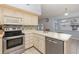 Well-lit kitchen featuring stainless steel appliances, tiled backsplash, and ample countertop space at 216 Kingshill Se Ct, Winter Haven, FL 33884