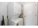 A laundry room with stacked washer and dryer units and a door leading to other parts of the house at 216 Kingshill Se Ct, Winter Haven, FL 33884