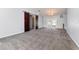 Spacious living room featuring plush carpeting, barn doors, neutral paint, and ample natural light at 216 Kingshill Se Ct, Winter Haven, FL 33884