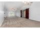 Expansive living room boasts vaulted ceilings, plush carpeting, neutral paint, and natural light at 216 Kingshill Se Ct, Winter Haven, FL 33884