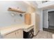 Utility area featuring built-in storage, cream-colored cabinets, and black safe for secure storage needs at 216 Kingshill Se Ct, Winter Haven, FL 33884
