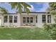 A view of the backyard with a covered patio and manicured lawn at 3067 Princewood Dr, Minneola, FL 34715