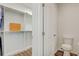 Bathroom featuring an adjacent toilet room and closet with custom shelving at 3067 Princewood Dr, Minneola, FL 34715