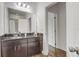 Bathroom featuring a granite vanity and wood-look tile floor at 3067 Princewood Dr, Minneola, FL 34715