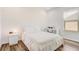 Bright bedroom featuring wood-look floors, window and contemporary furnishings at 3067 Princewood Dr, Minneola, FL 34715