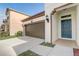 Home exterior featuring a two-car garage, blue front door, and well-maintained lawn at 3067 Princewood Dr, Minneola, FL 34715