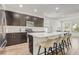 Modern kitchen with barstool seating, stainless steel appliances, and sleek cabinets at 3067 Princewood Dr, Minneola, FL 34715