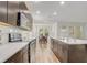 Open kitchen showcasing stainless steel appliances and a center island with quartz countertops at 3067 Princewood Dr, Minneola, FL 34715