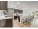 Spacious kitchen with stainless steel appliances, a large island, and bar stool seating at 3067 Princewood Dr, Minneola, FL 34715