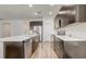 Bright kitchen with stainless steel appliances, dark cabinets, and a large island at 3067 Princewood Dr, Minneola, FL 34715