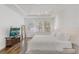 Bright main bedroom boasts tray ceilings, wood-look floors, and abundant natural light at 3067 Princewood Dr, Minneola, FL 34715
